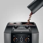 Gepreserveerde koffiebonen in koffiemolen met moderne digital bediening.